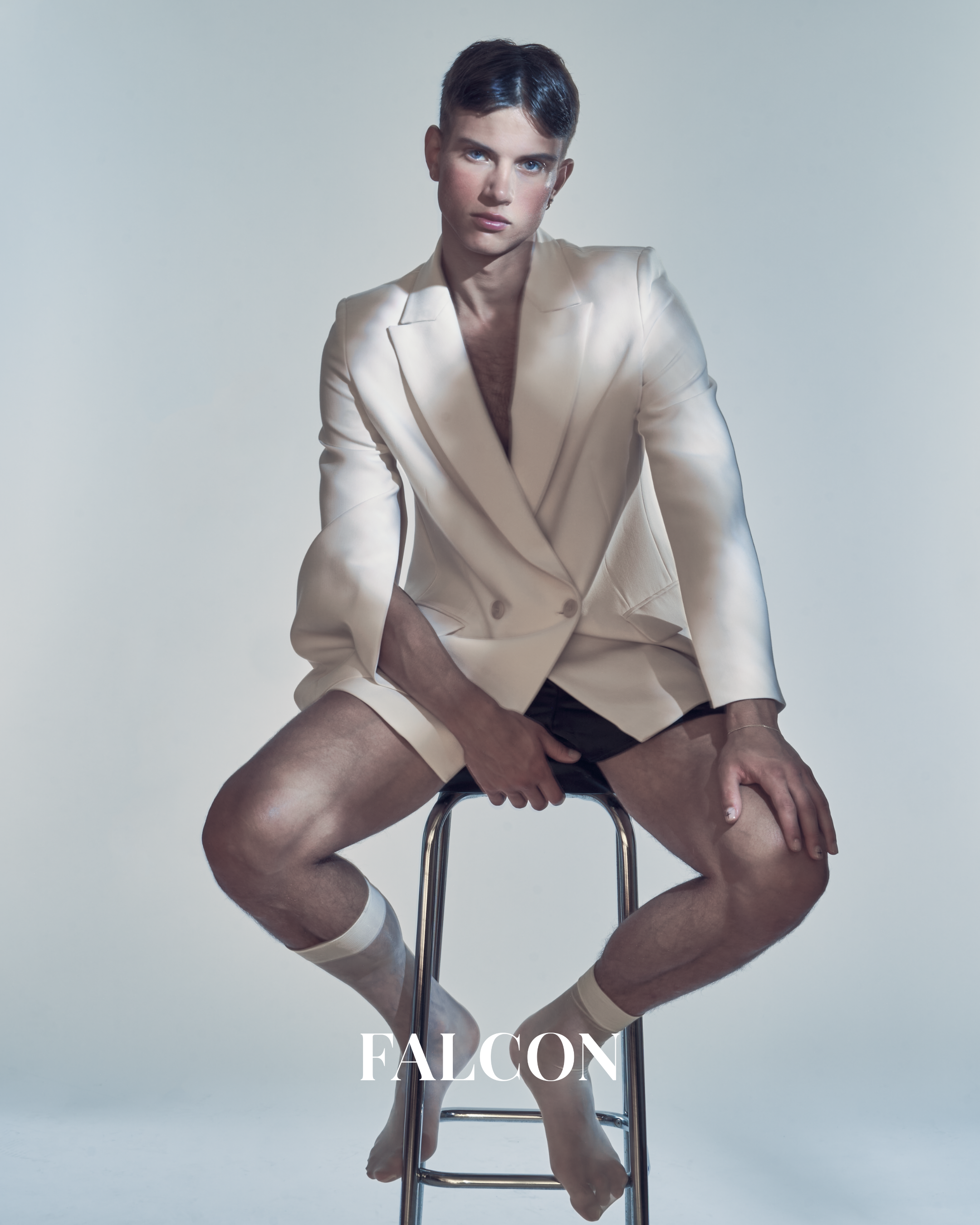 Cinematic fashion editorial portrait with refined studio lighting, showcasing narrative-driven editorial photography by a Belgian fashion photographer.