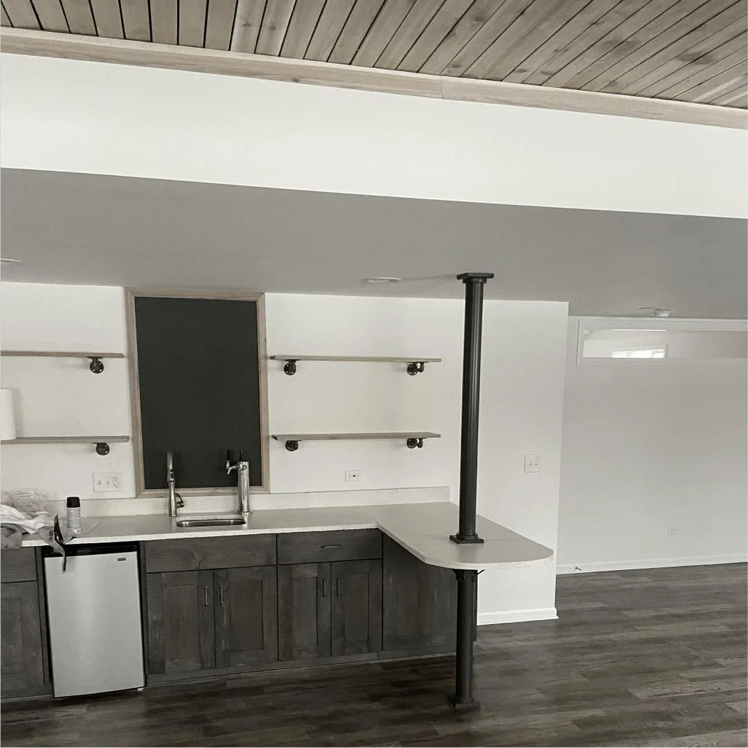 Did you know basement bars don't have to be dark and dreary? We think this update we did is a perfect example of how fresh and clean a basement space can be!

#wednesdaywork #perfectbasementbar #elevationcarpentry #taptower #chalkboardtaplist #concre