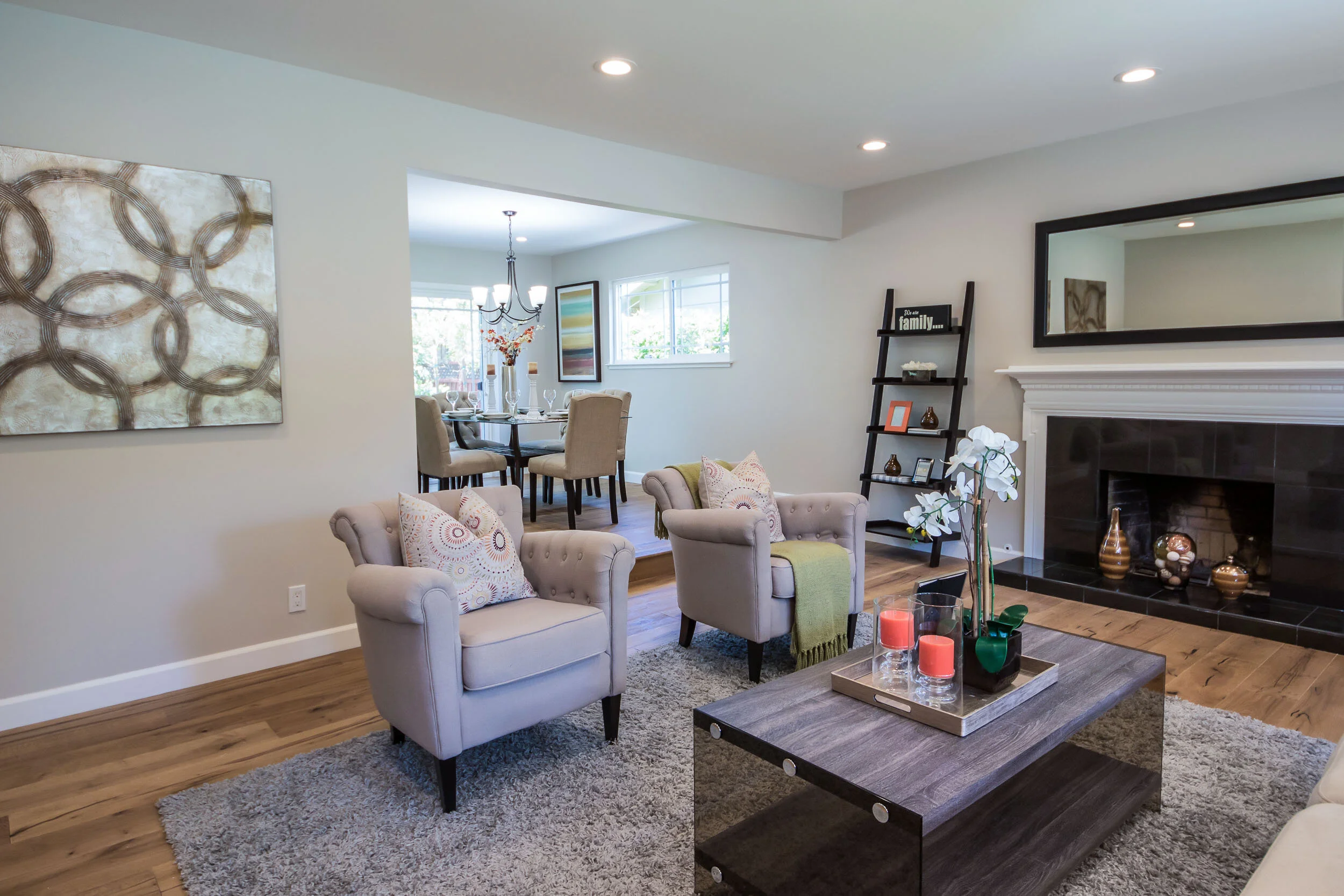 Formal living room with new flooring and fireplace mantle