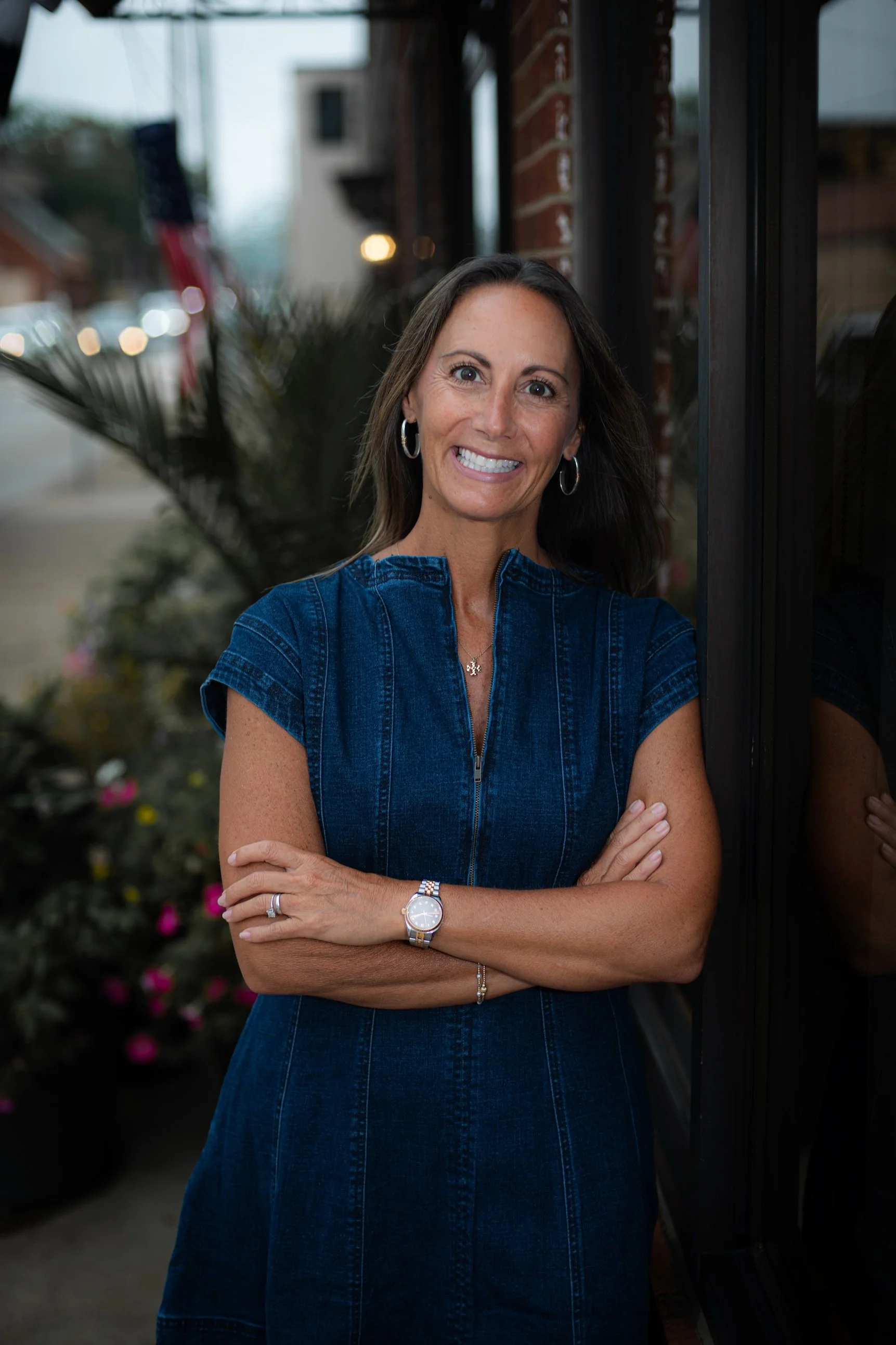a woman smiling with her arms crossed