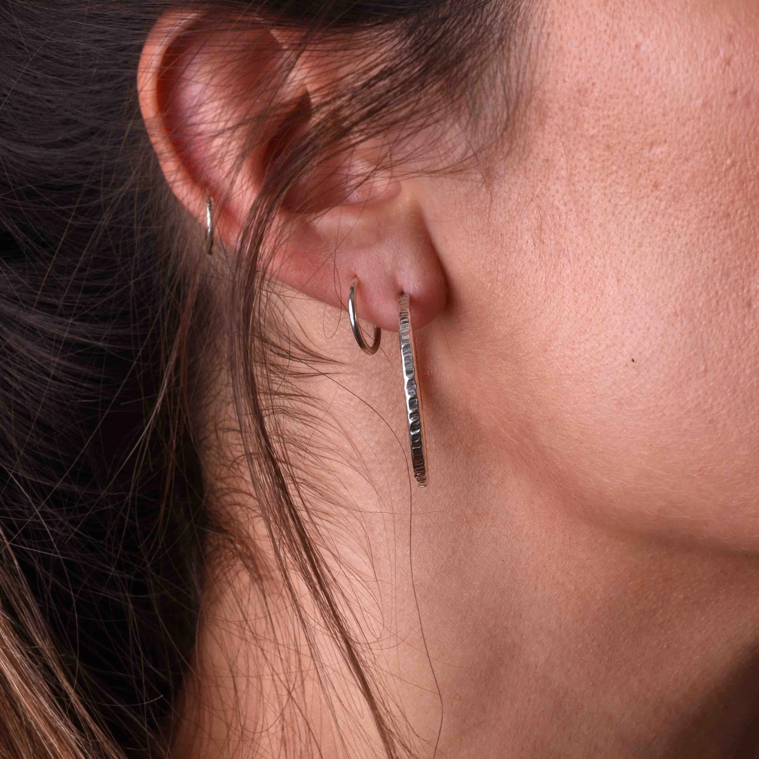 Linear Hoops silver in ear 2.jpg