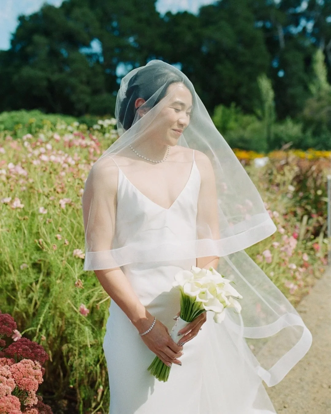 Alyssa + Jerry&rsquo;s lush, floral elopement at Filoli Gardens. I remember looking up at one point and seeing the sky. It was wild. Mid day sun, high in the sky, peeking in and out from behind this huge bed of small, magical puffy clouds. Making pic