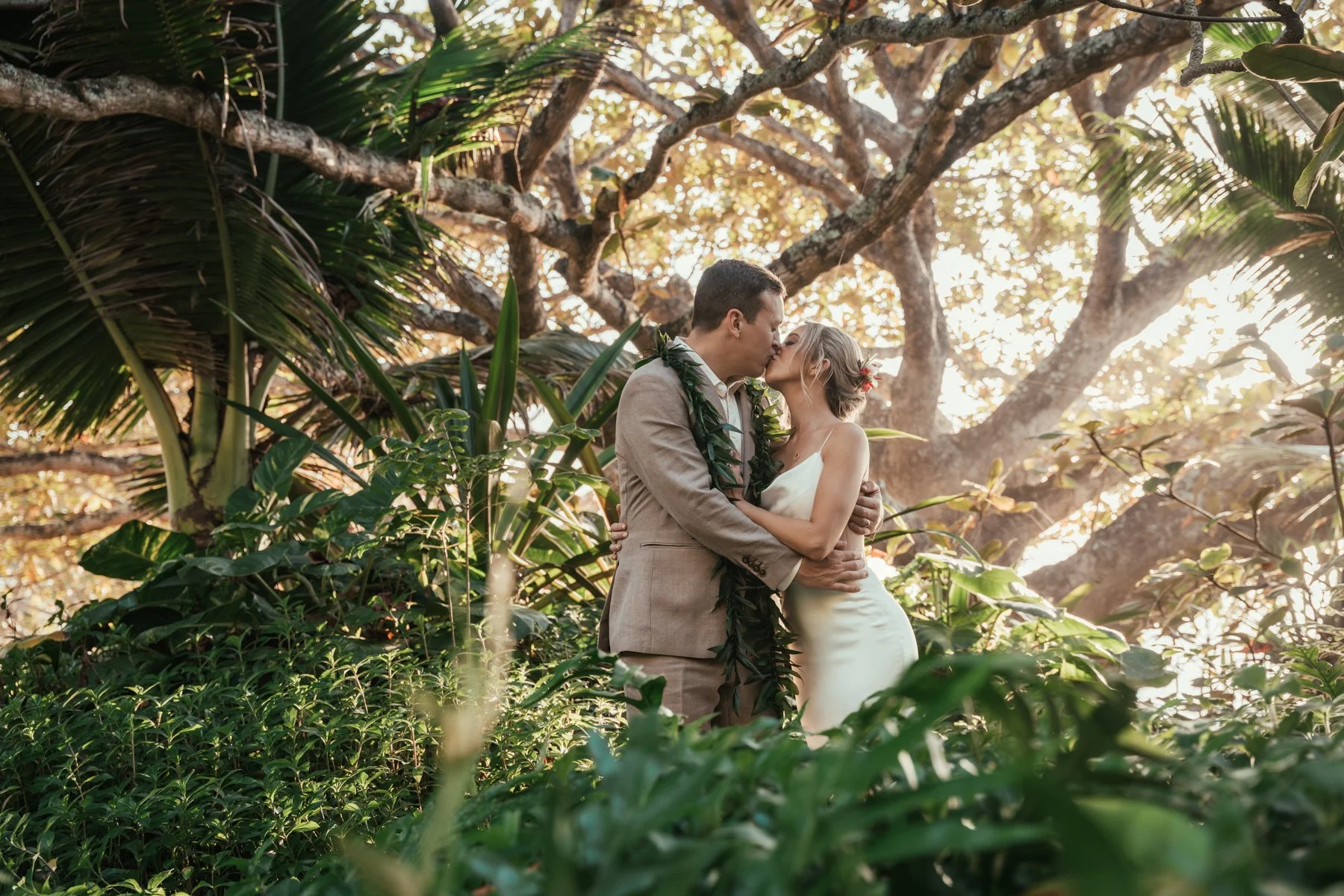 Bride and groom in jungle at the 1 Hotel Hanalei Bay
