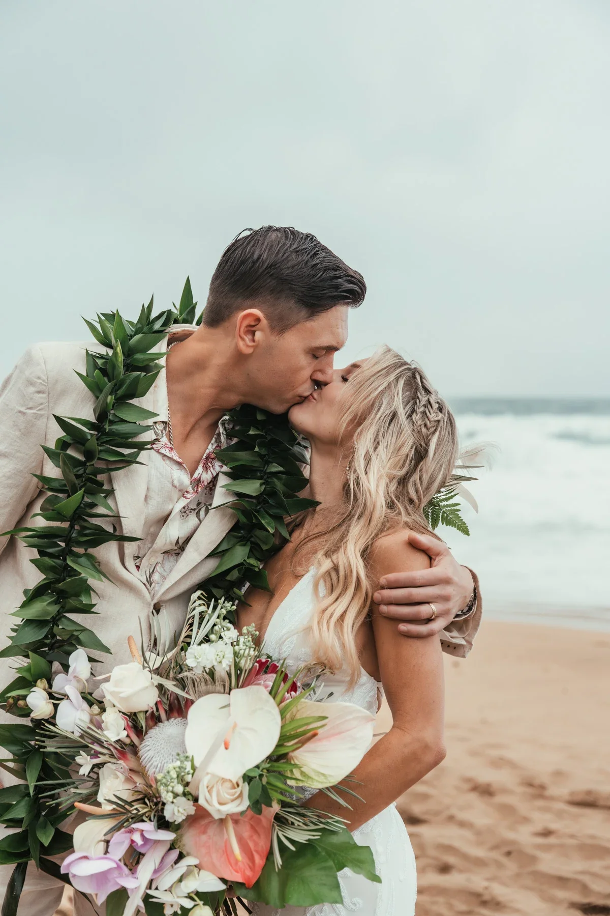 Couple kissing on a North Shore beach during their Kauai elopement