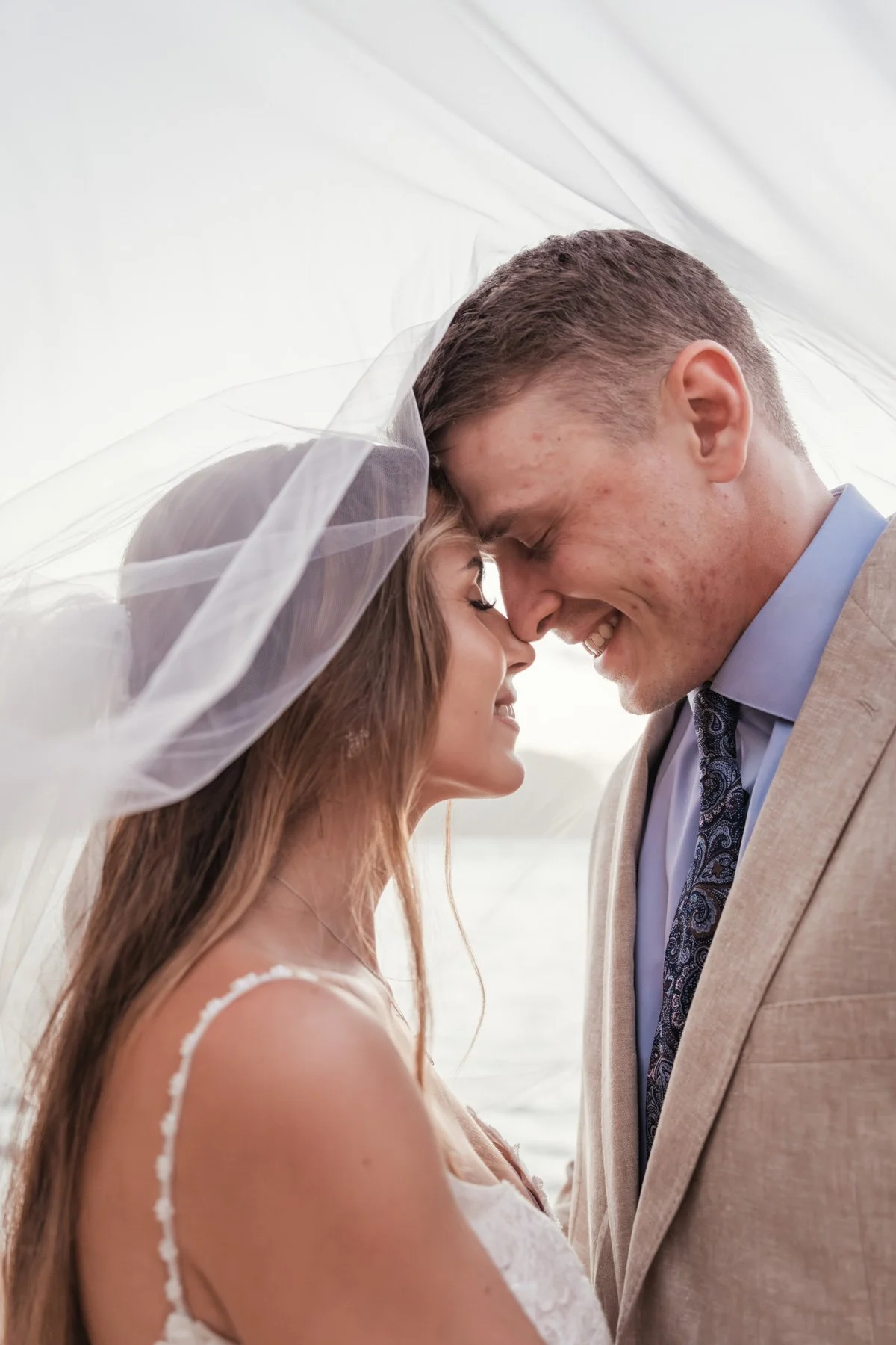Wedding bride and groom under veil