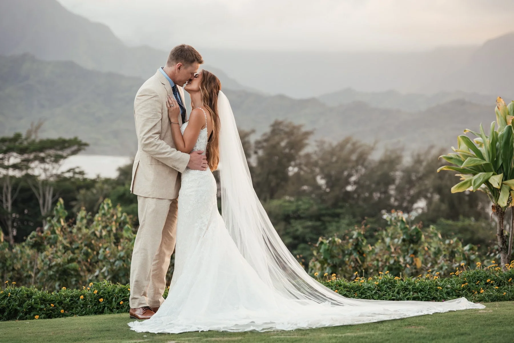 Bride and groom kissing during sunset at Kauai
