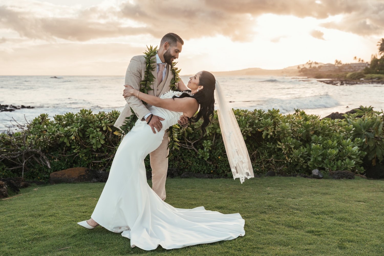 bride and groom pose for wedding photo at sheraton kauai resort in poipu