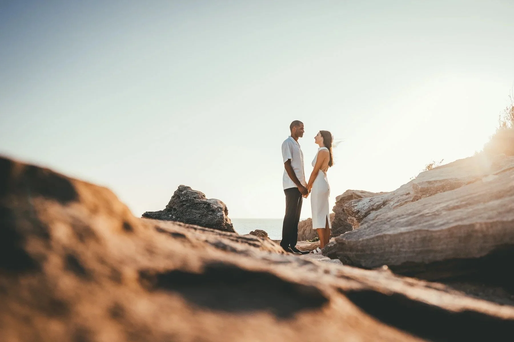 couple holding hands during sunset elopement at Shipwreck Beach
