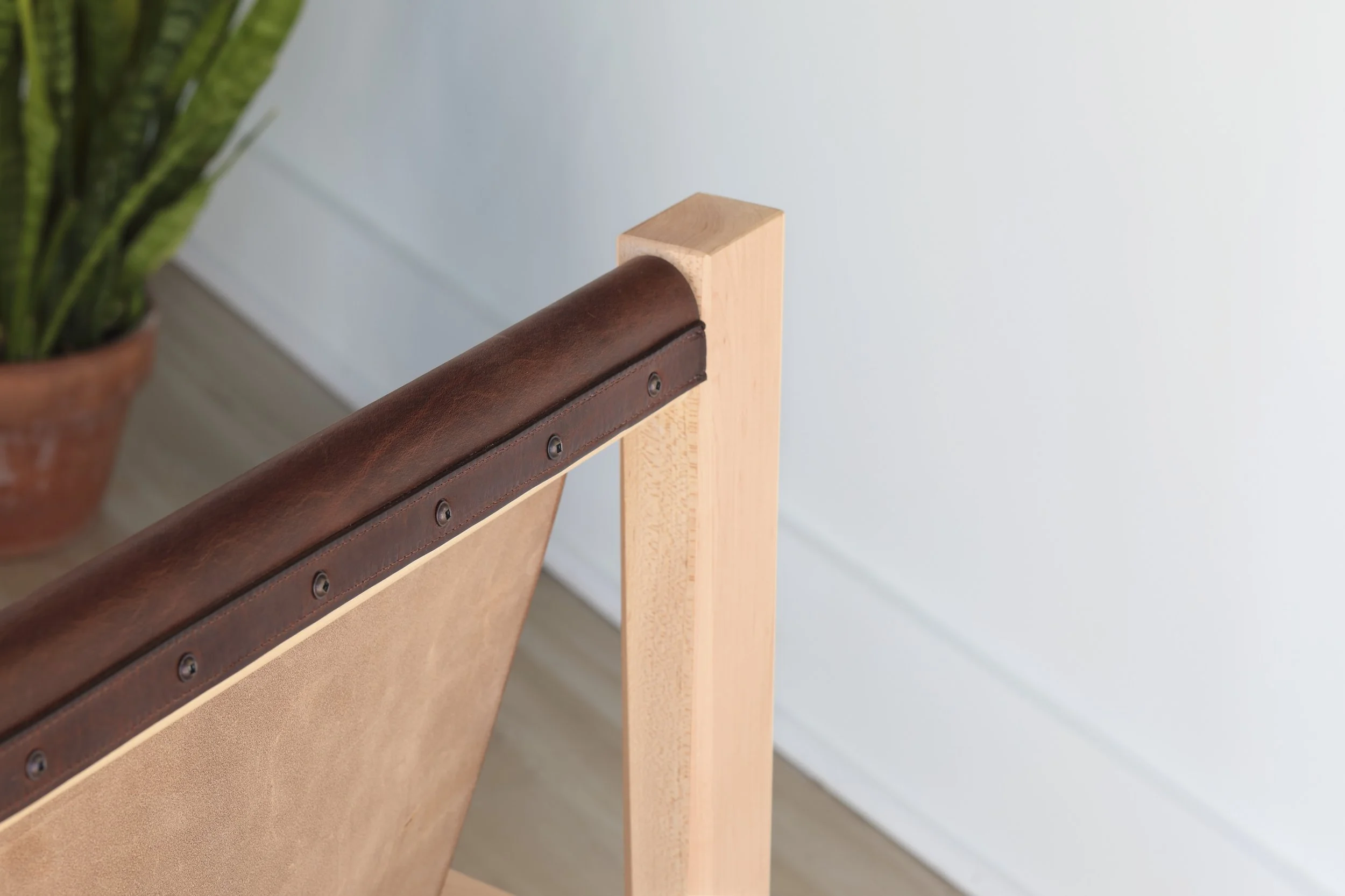 Combining the warmth of wood and the luxury of leather, this sling chair is the perfect place to spend an evening of relaxation. A collaboration between Alicia Dietz Studios and Awl Snap Leather, both women-owned business in Richmond, VA. A low and d