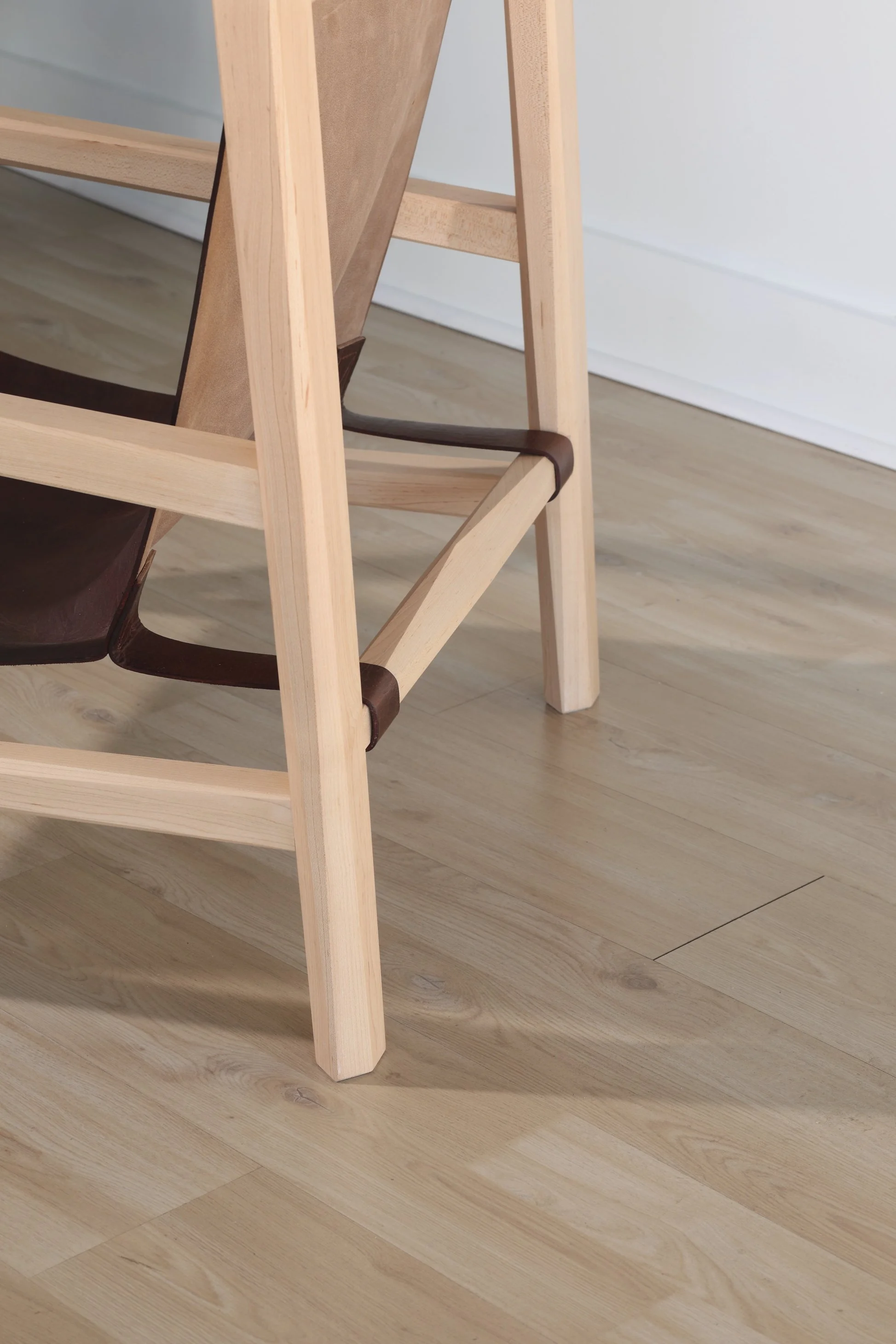 Combining the warmth of wood and the luxury of leather, this sling chair is the perfect place to spend an evening of relaxation. A collaboration between Alicia Dietz Studios and Awl Snap Leather, both women-owned business in Richmond, VA. A low and d