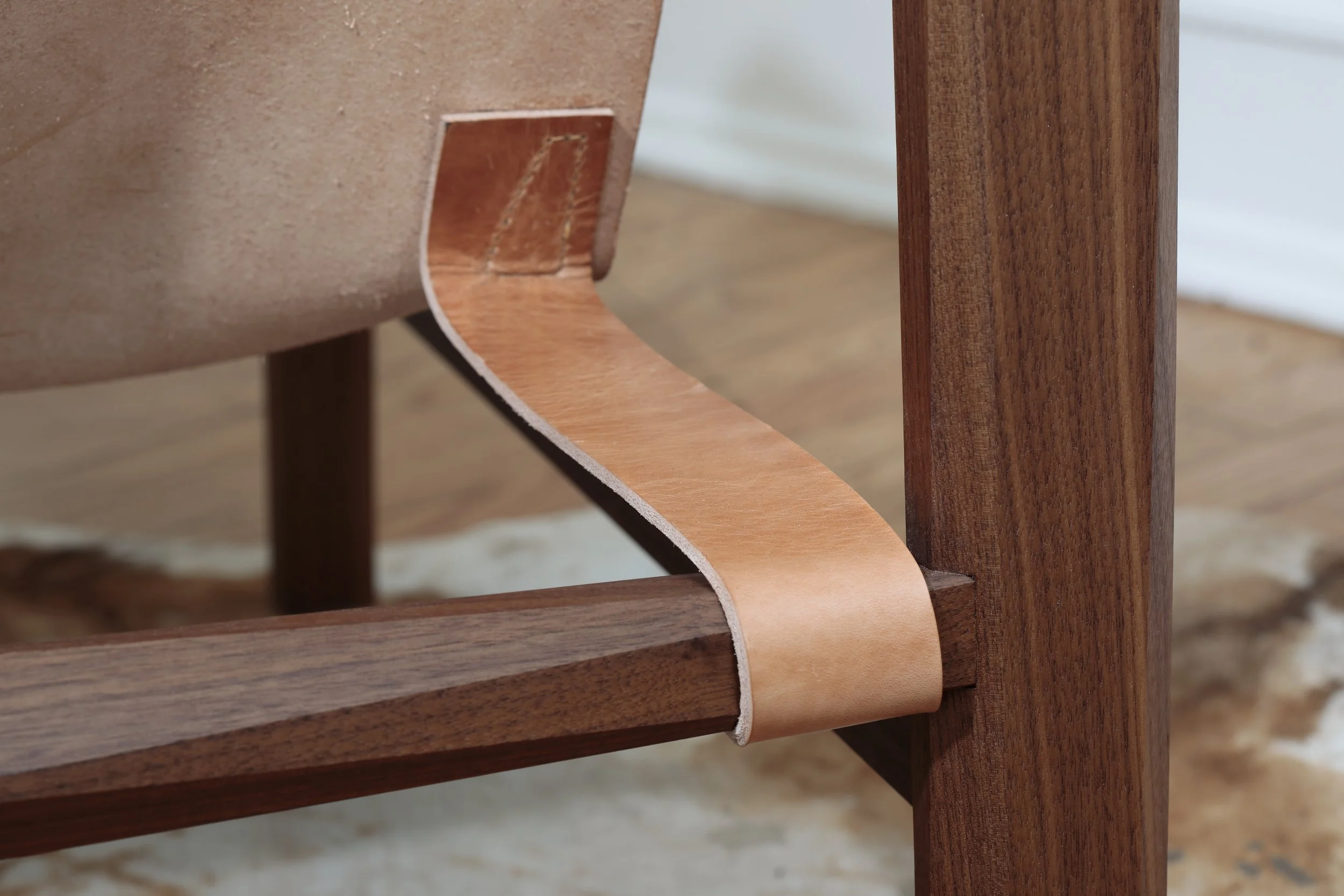 Combining the warmth of wood and the luxury of leather, this sling chair is the perfect place to spend an evening of relaxation. A collaboration between Alicia Dietz Studios and Awl Snap Leather, both women-owned business in Richmond, VA. A low and d