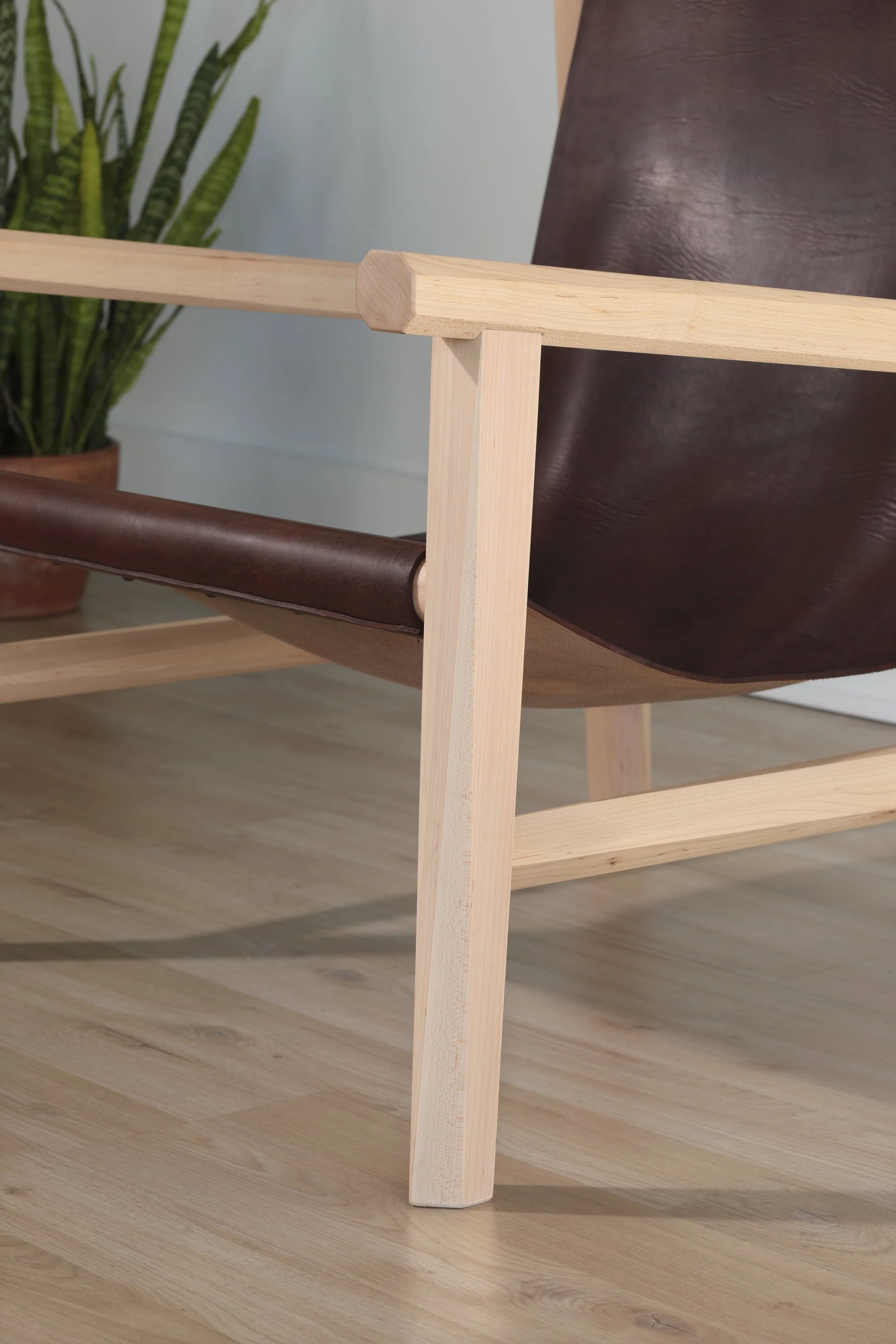 Combining the warmth of wood and the luxury of leather, this sling chair is the perfect place to spend an evening of relaxation. A collaboration between Alicia Dietz Studios and Awl Snap Leather, both women-owned business in Richmond, VA. A low and d
