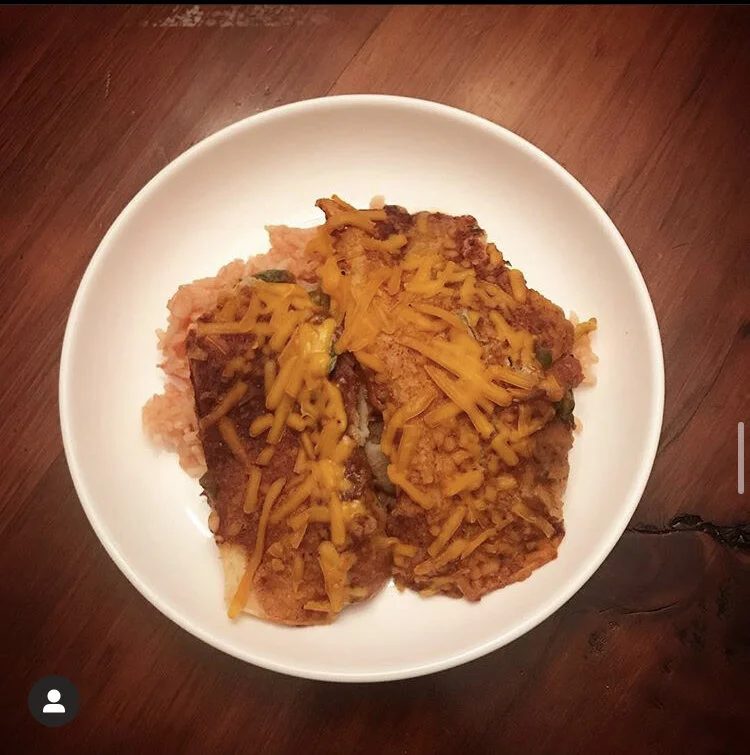 Vegan Enchiladas - stuffed with refried beans, corn, spinach, enchilada sauce, vegan cheddar, served on a bed of Vegetarian Mexican rice.  