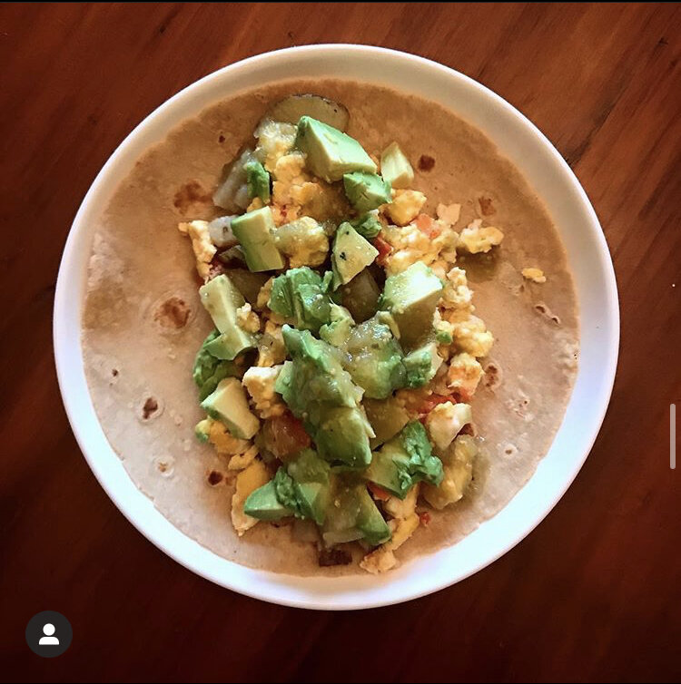 Breakfast Burrito - Egg, Tomato, Potato scramble, topped with avocado, & green salsa, in a flour tortilla.  