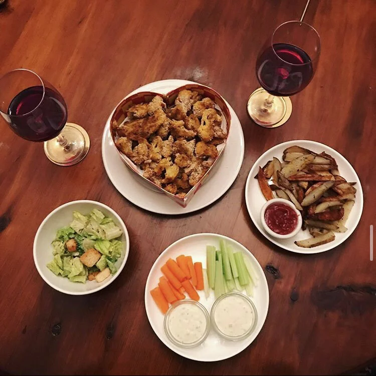 Cauliflower Wings with a secret blend of Herbs & spices - Steak Fries with pepper, parsley, garlic powder & onion powder - Cesar Salad - carrots & Celery 