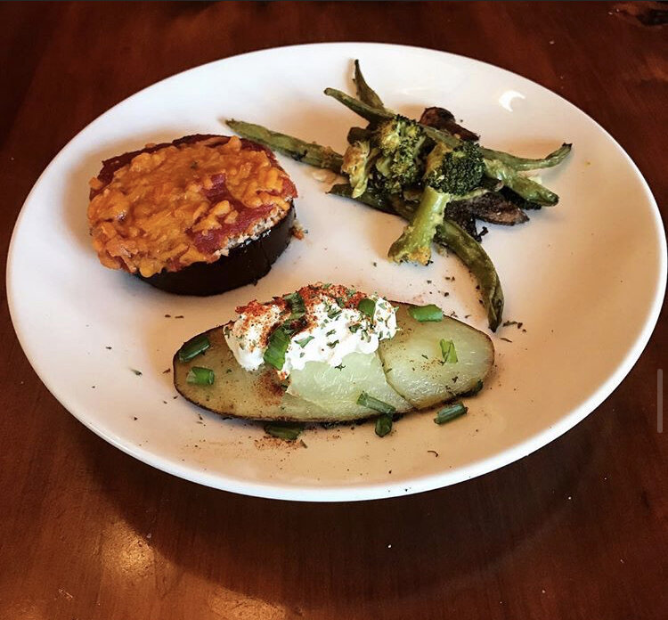 Eggplant parmigiana bites, roasted vegetable medley (asparagus, broccoli, & mushrooms), and an open faced baked potato with our cream, chives,  paprika, and parsley. 