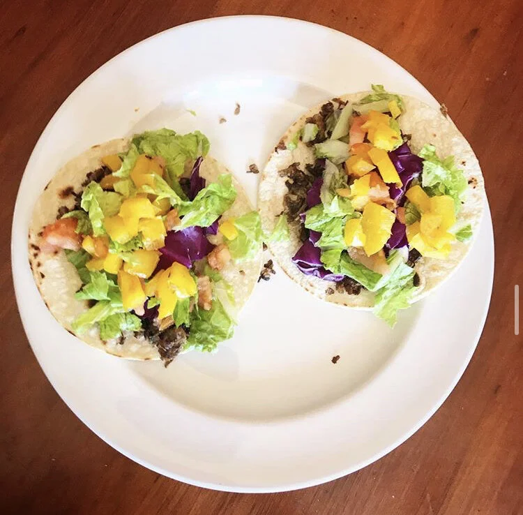 "Carnitas" (Mushrooms) tacos, with lettuce, tomatoes, purple cabbage, bell peppers, and lime 