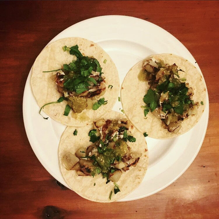Potato Tacos - Fried Potatoes with vegan cheese, green salsa, cilantro, and lime 