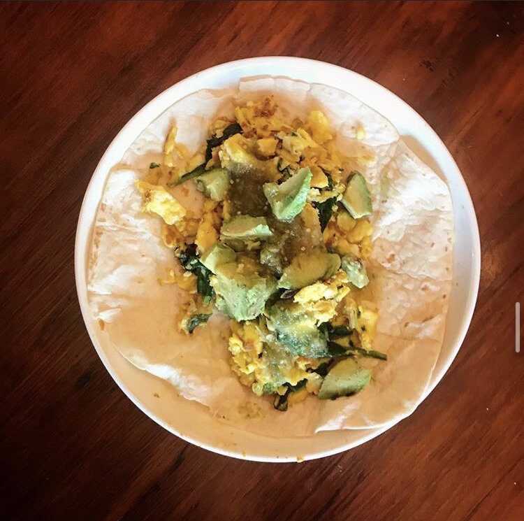 Spinach Egg scramble topped with avocado & salsa
