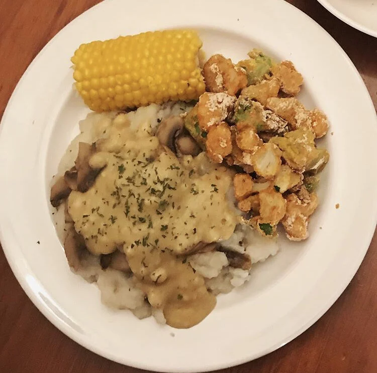 Fried Cauliflower/Broccoli Bitswith mashed potatoes, topped with homemade mushroom gravy & parsley, with a side of steamed corn 