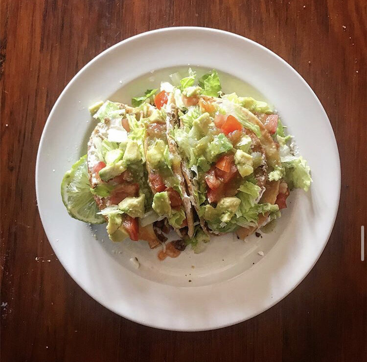 Veggie Tacos -Soy Meat Crumbles, Dairy Free cheese, Dairy Free sour cream, Chopped Lettuce, Fried Corn Tortilla, Tomatoes, avocados, and green salsa 