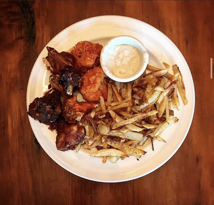 Buffalo & BBQ Cauliflower Hot wings with thin cut steak fries, and a side of vegan ranch