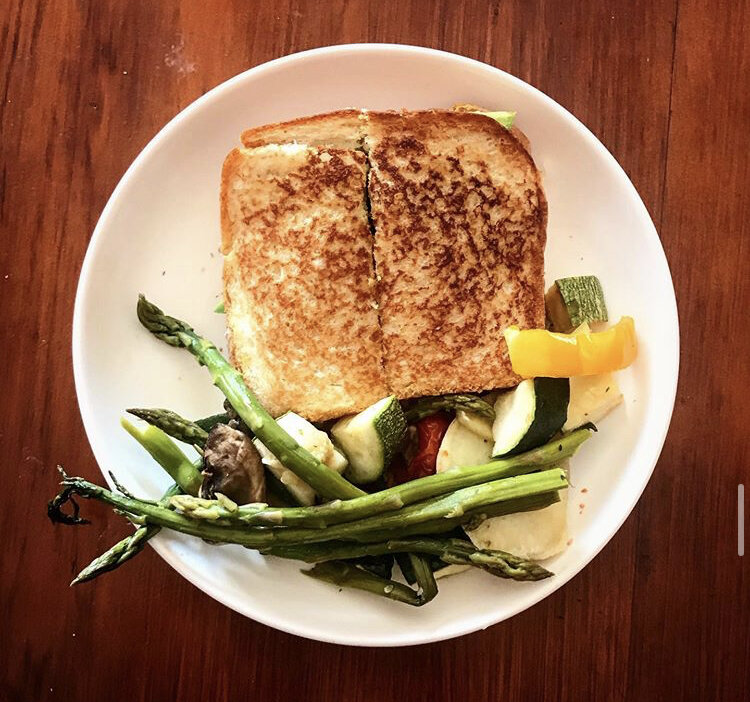 Grilled Cheese with Avocado, vegan Mozzarella, & tomato. Served with roasted veggie: asparagus, zucchini, mushrooms, bell pepper, sweet potato, tomatoes, and broccoli 