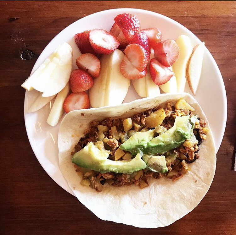 Breakfast burrito - avocado, soyrizo, egg, potato, salsa. with strawberries & apples 