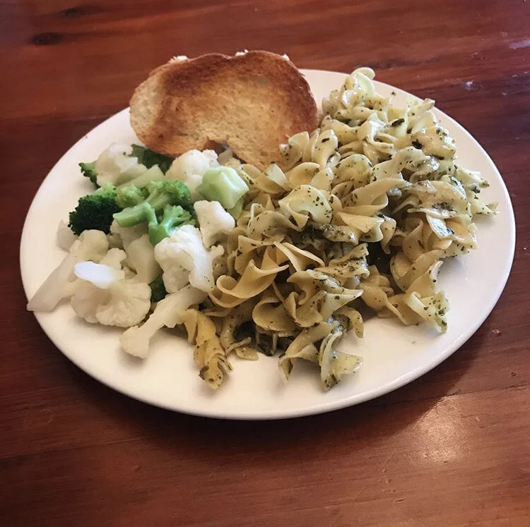Pesto pasta, steamed veggies, and french bread 