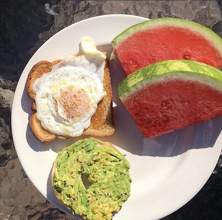  avocado on bagel, watermelon, toast with a fried egg