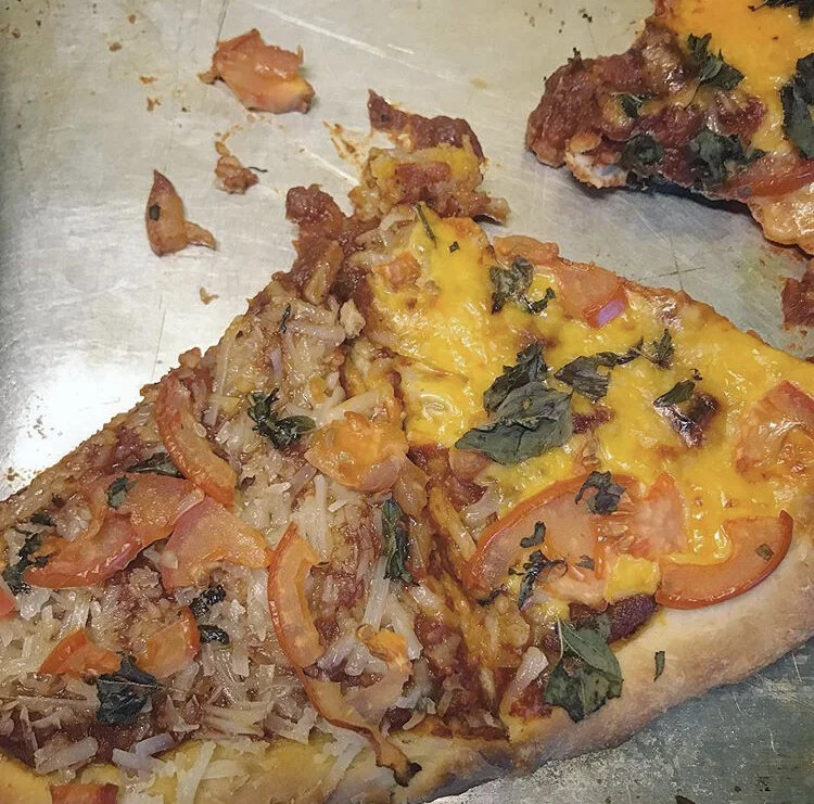 Pizza from scratch -toppings: vegan cheese (cheddar & mozzarella), basil, & tomatoes