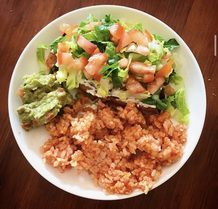 Tacquitos (mushroom / potato) dressed with lettuce, and tomatoes, served with mexican rice