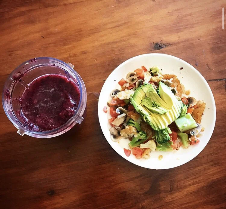 Mushroom, tomatoes, broccoli, hash brown, and avocado, with a side of pineapple/blueberry smoothies 
