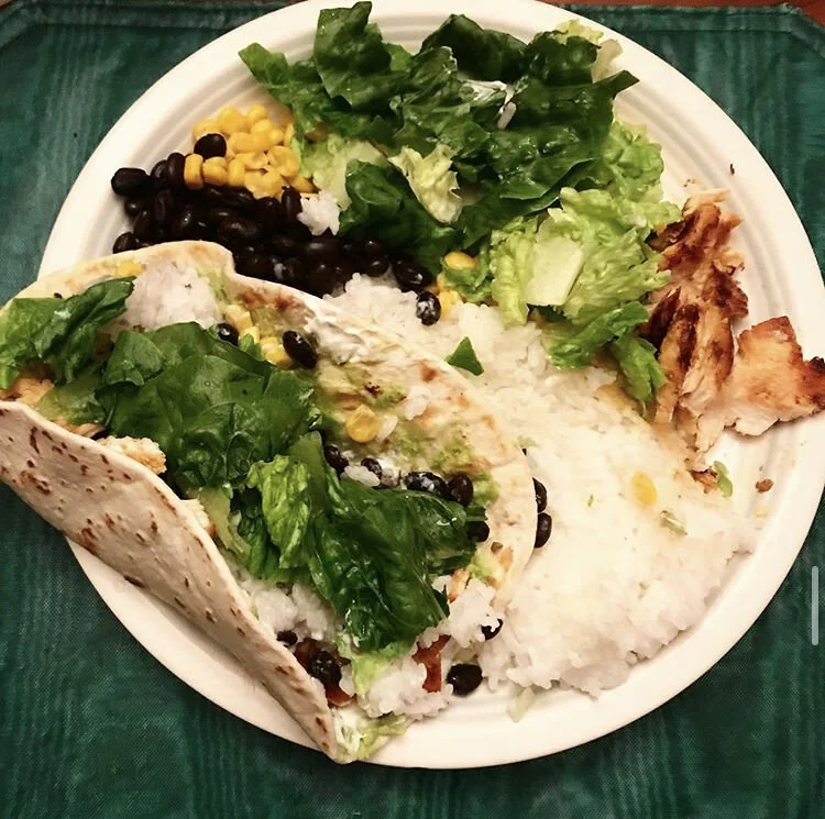 black Beans, white rice, corn, lettuce, chicken, sour cream, green salsa, avocado, and tortillas 
