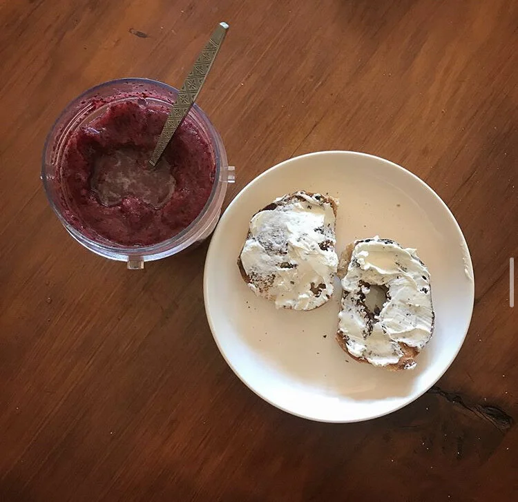 Bagel with cream cheese  & a smoothie with banana cherries, blueberries, and pineapple 