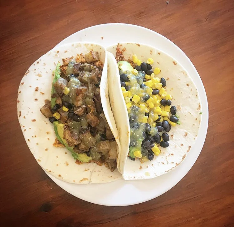 Two soyrizo & egg burritos. 1 with potato avocado & salsa. 1 with corn, beans, avocado, and salsa 
