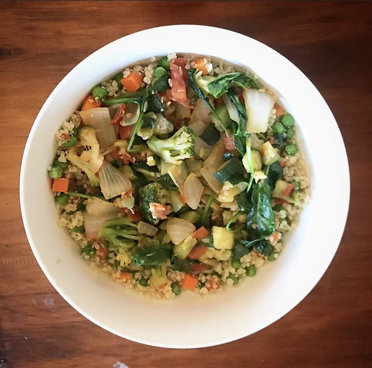 Health is wealth bowl, quinoa, peas, carrots, broccoli, zucchini, onions, tomatoes, spinach 