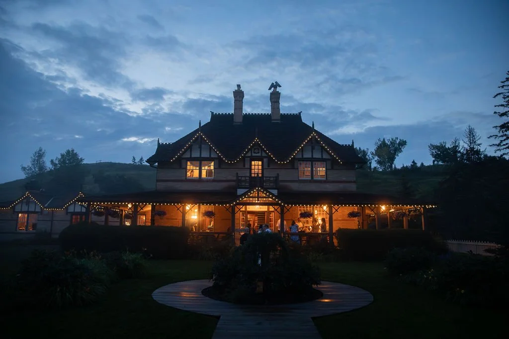 a night time view of the bow valley ranch house at the conclusion of a beautiful, intimate wedding.