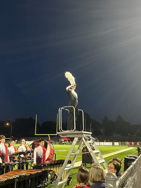 Lehner saluting from the drum major podium.