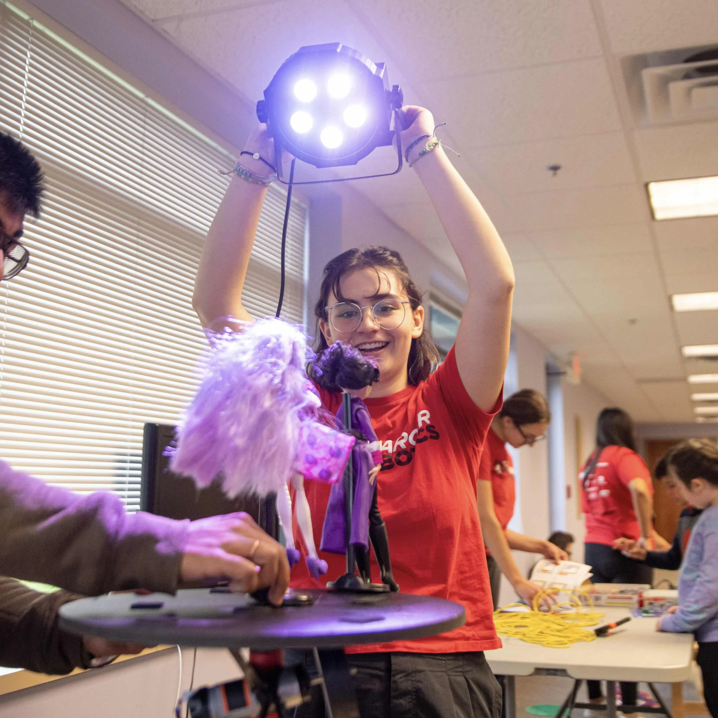 Charger Robotics team members spread STEM at a local theater company.