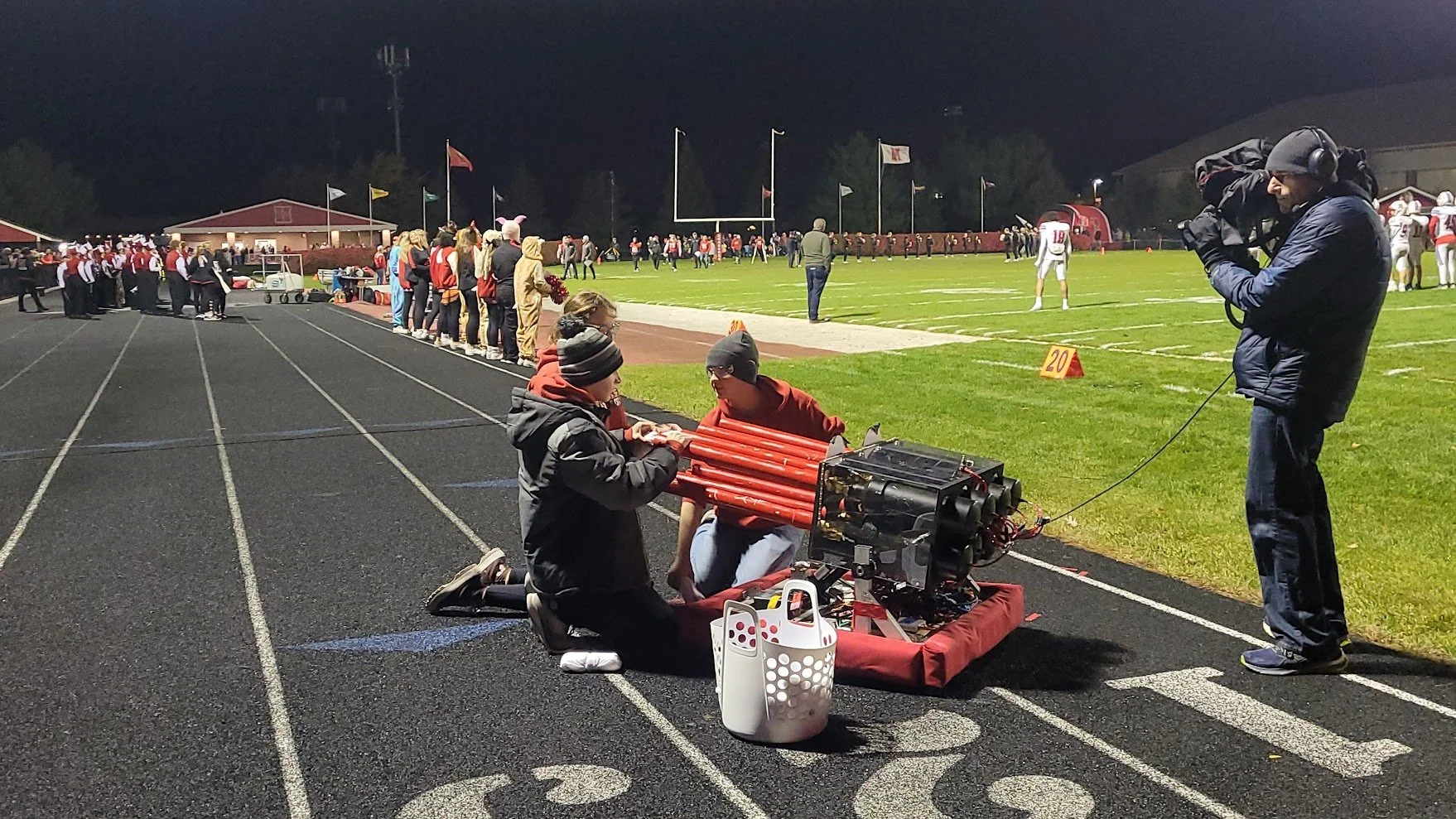 Team 537 operates their T-shirt cannon, Sonic Boom, at a football game.