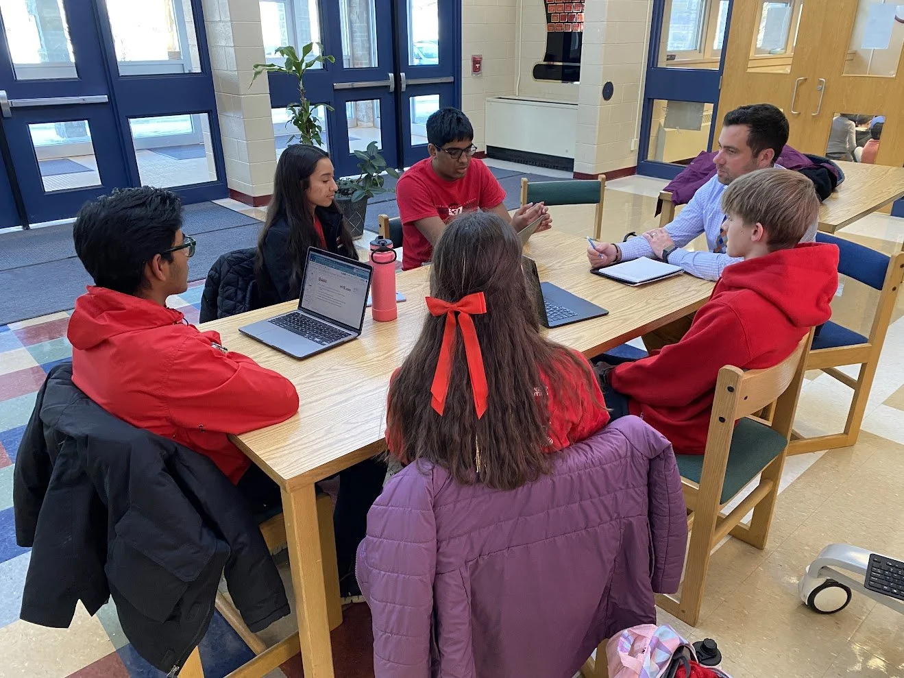 Charger Robotic's Impact Team pitches the FLL Explore program to Lannon.