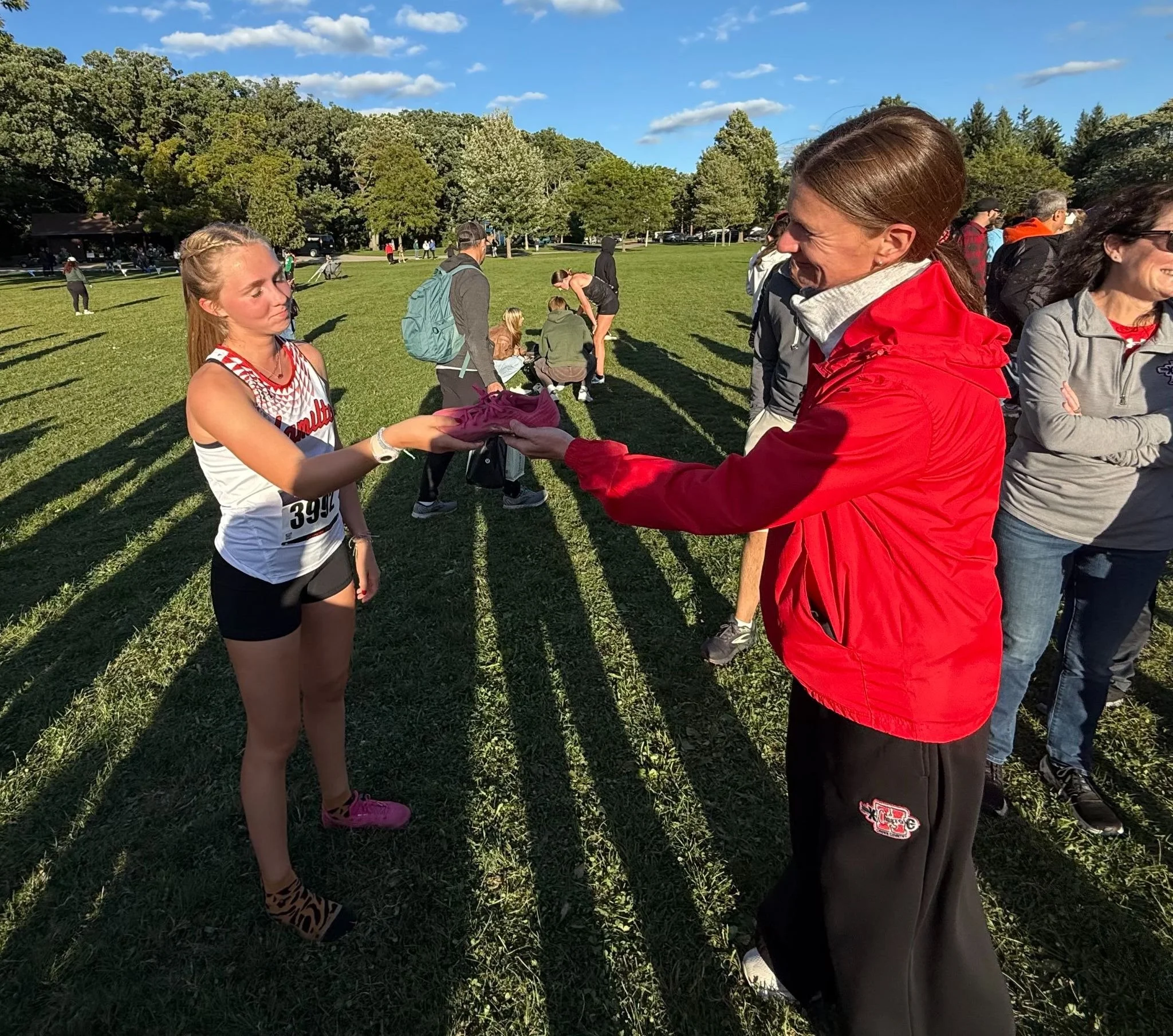 Finally getting her spike back after running the race without a shoe (someone found it in the woods). 