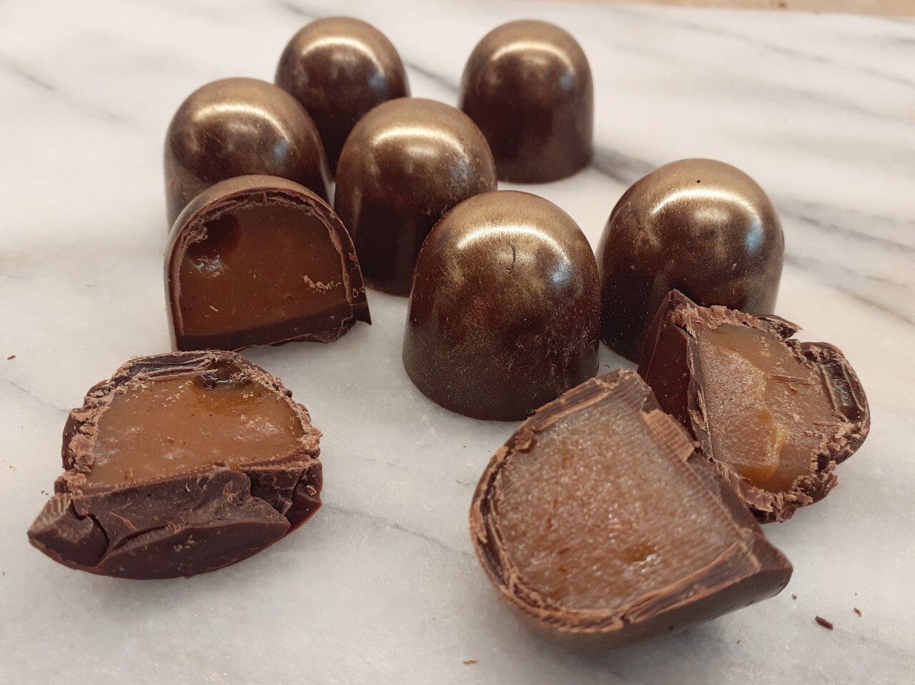 dark chocolates filled with soft caramel on a plate