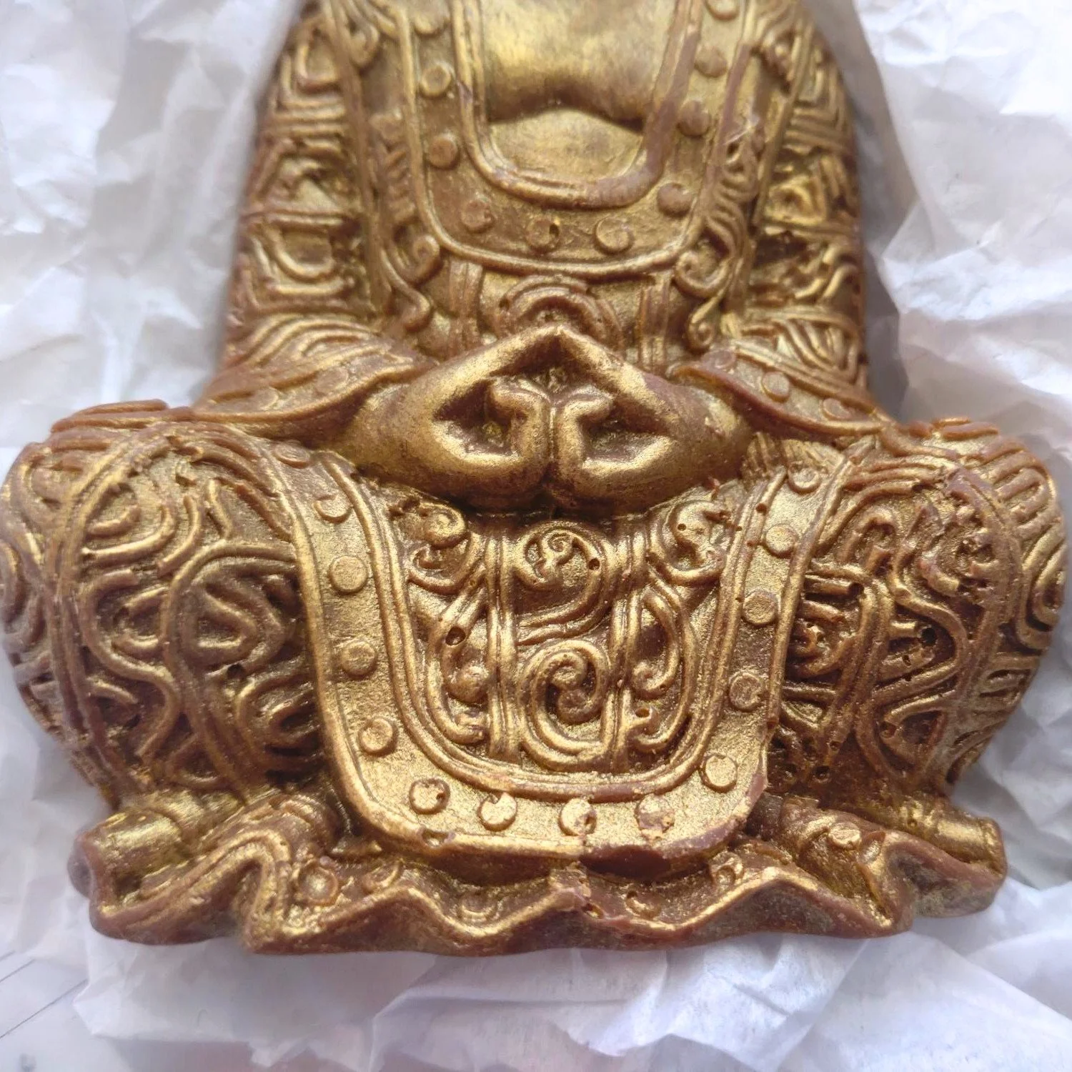 Close-up of handmade chocolate Buddha figure showing detail