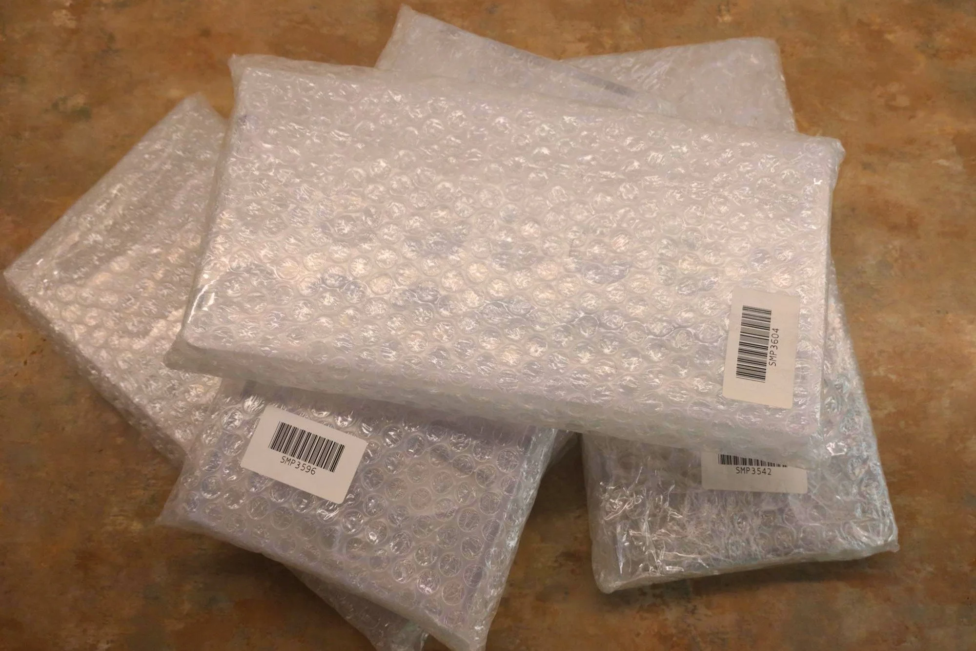 A stack of new chocolate moulds wrapped in bubble wrap