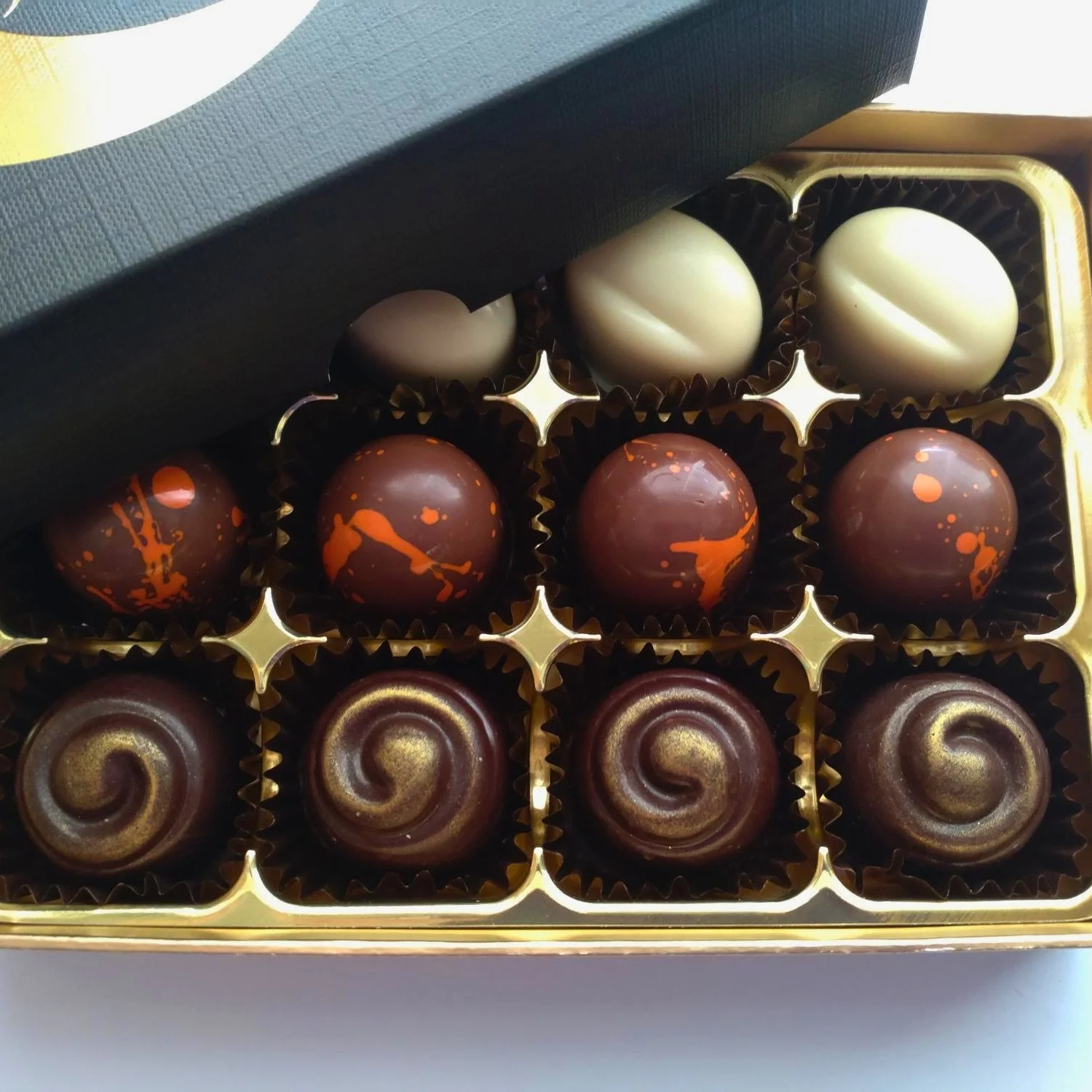 Gift box of handmade Japanese-inspired chocolates from Truffle Witch, including yuzu, matcha and ginger, and miso caramel varieties.