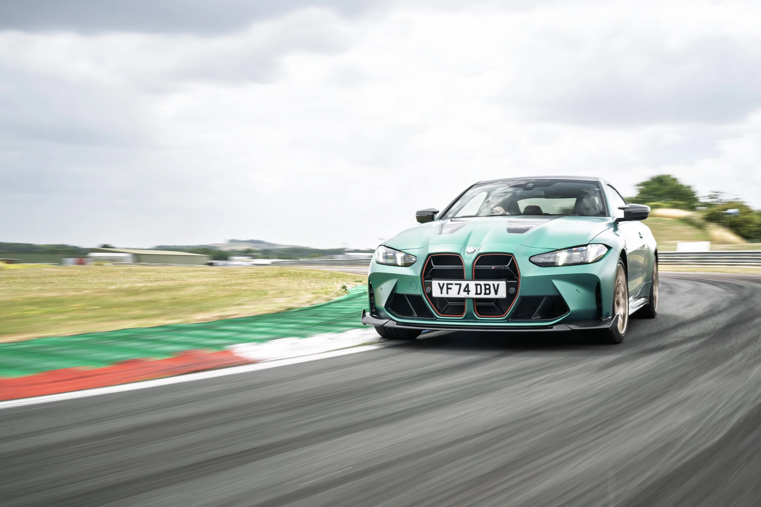 A light blue high-performance sports car racing on a track.