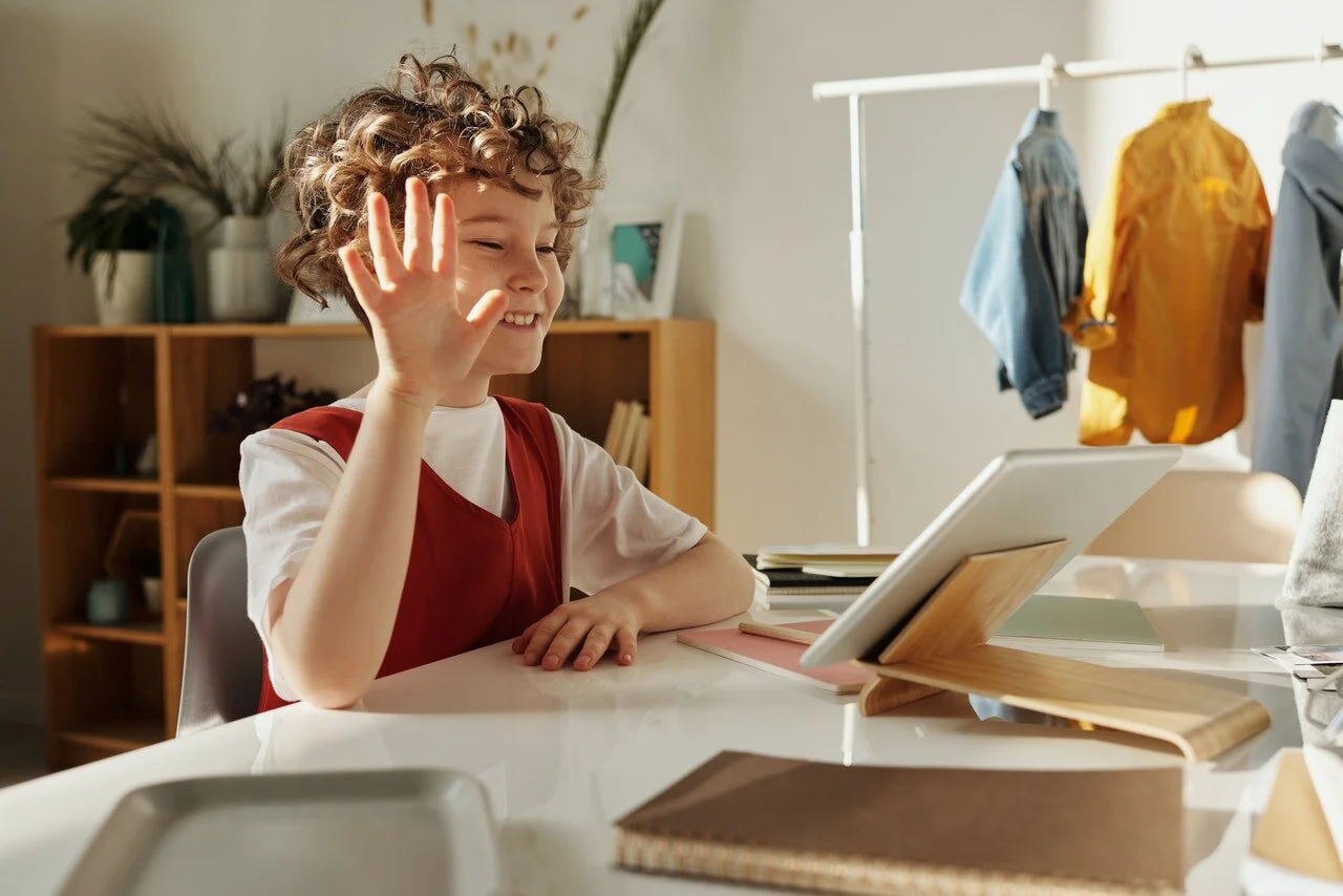 photo-of-child-smiling-while-using-tablet-computer-4145032.jpg