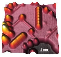 Image STM image of two artificial bits of seven iron atoms each: one vertically oriented (top) and one diagonally oriented (bottom left)